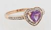 Lady's 14K Yellow Gold Dinner Ring, with a heart shaped amethyst, atop a pierced diamond mounted border, the sides of the band also...