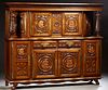 French Provincial Carved Oak Sideboard, 20th c., Brittany, the stepped dentillated crown over double cupboard doors with brass fiche...