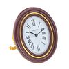 Reloj despertador Cartier Ref 7509. Movimiento manual. Caja oval en acero dorado. Bisel en resina color guinda.