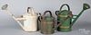 Three painted tin watering cans