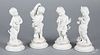 Set of four bisque and porcelain putti figures