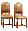 Pair of chairs. 20th century. Carved in wood. With closed backrests and brown leatherette seats.