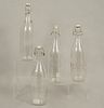 Lot of 4 bottles. 20th century. Made in glass. 12.5 x 3" (32 x 8 cm)