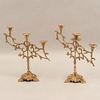 Pair of candle holders. Twentieth century. In brass. For 3 lights each. With floral washers, tubular shafts and openwork arms.