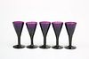 A SET OF FIVE AMETHYST GLASS PORT OR SHERRY GLASS