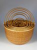 Nest of Eight Bill and Judy Sayle Round Open Swing Handle Nantucket Baskets, 1983