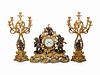 A Louis XV Style Gilt and Patinated Bronze Clock Garniture