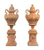 A Large Pair of Neoclassical Terra Cotta Covered Urns on Stands