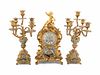 A Louis XV Style Gilt Bronze and Champleve Enamel Clock Garniture