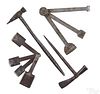 Four wrought iron button hole cutters and hammers