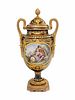 A Sevres Style Gilt Bronze Mounted Painted and Parcel Gilt Porcelain Covered Urn