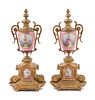 A Pair of Sevres Style Gilt Metal Mounted Painted Porcelain Ornaments