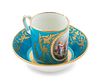 A Sevres Style Painted, Parcel Gilt and "Jeweled" Turquoise-Ground Porcelain Cup and Saucer