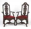 A pair of Continental carved wood armchairs