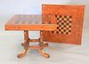 Contemporary game table set on pedestal base having backgammon and checkerboard top.