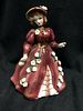 VINTAGE ESD JAPAN FIGURINE OF A PRETTY LADY IN A BURGUNDY DRESS WITH FLOWERS