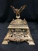 EMBOSSED ANTIQUE BRASS INKWELL WITH AN EAGLE ON THE TOP