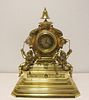 Antique Brass Figural Clock With Bell Finial.