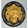 A HIGH RELIEF DIVISION 1 IVOROID LION HEAD IN METAL