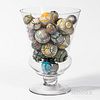Approximately Thirty Carpet Balls in a Large Blown Glass Vase