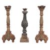 Lot of 3 candelholders. 20th century. Different designs. Carved in wood. With floral washers, 2 with architectural shafts.