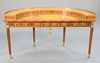 William Tillman half-round desk having three section inset leather and tilting center section and brass gallery, sunbleached, ht. 34", wd. 60".