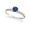 A 14CT SAPPHIRE AND DIAMOND RING, the round sapphire in a four-claw mount, 