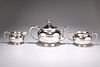 A CHINESE SILVER THREE PIECE TEA SERVICE, by Wang Hing & Co, late 19th/earl