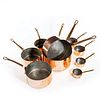 Collection of 10 vintage graduating copper pans with brass handles, circa 1930 - Courtesy William Cook Antiques, UK
