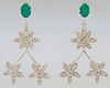 Pair of 14k White Gold Pendant Earrings, with an oval emerald mounted stud suspending three flowers with diamond mounted petals, tot...