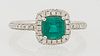 Lady's 14k White Gold Dinner Ring, with an octagonal step cut, 1.13 carat emerald atop a border of tiny diamonds, supported by a dia...