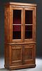 French Louis Philippe Carved Cherry Bookcase Cupboard, 19th c., the rounded crown over double glazed doors, atop a base with two cupboard doors, on a 