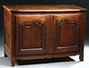 French Louis XV Style Carved Walnut Sideboard, 19th c., the top hinged and lifting to open storage over double arched fielded panel cupboard doors, wi