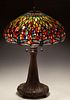 Tiffany Style Dragonfly Table Lamp, late 20th c., by Dale Tiffany, the slag glass shade mounted with numerous cabochon "jewels," on a naturalistic bro