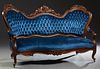 American Rococo Revival Carved Mahogany Settee, 19th c., the serpentine chair back with three pierce carved floral crests, over a tufted upholstered b
