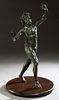 Continental School, "The Dancing Satyr," 20th c., patinated bronze, after the Roman original discovered in Pompeii in 1830, on a circular wooden plint