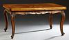 Louis XV Style Carved Mahogany Draw Leaf Dining Table, early 20th c., with a geometric inlaid top and leaves, above a floral and leaf carved shaped sk