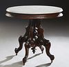 American Carved Walnut Oval Marble Top Table, c. 1880, the white ogee edge marble on a base with an incised sloping skirt, on a tapered urn support ce