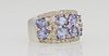 Lady's 14K White Gold Dinner Ring, the tapering wide top with 8 oval .2 ct. tanzanites, separated by small round diamonds, within an edge border of sm