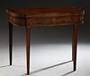 English Inlaid Mahogany Hepplewhite Style Games Table, 20th c., the serpentine bowed top over a wide skirt, on tapered square legs, the rear legs exte