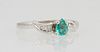 Lady's 14K White Gold Dinner Ring, with a .7 carat pear shaped emerald, flanked by curved shoulders mounted with graduated baguette diamonds, Size 6 3