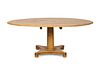 A Regency Style Pine Tilt-Top Extension Table
Height 30 x diameter 54 inches.