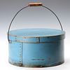 A LARGE CIRCULAR BENTWOOD PANTRY BOX IN OLD BLUE PAINT