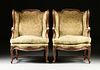 A PAIR OF LOUIS XV STYLE UPHOLSTERED AND CARVED WALNUT BERGÈRES A LA OREILLES, THIRD QUARTER 20TH CENTURY,