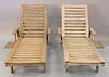 Two teak lounges, each with pull out tables, lg. 78".