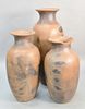 Three outdoor terracotta urns, one with chipped rim, ht. 33", 36 1/2", 47". Estate of Marilyn Ware Strasburg, PA.