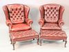 Pair of tufted leather upholstered wing chairs, both with ottomans, ht. 41", wd. 34".