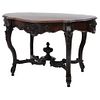 Table, Early 20th century, Victorian style, Carved and ebonized wood decorated with plant motifs and a drawer.