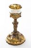 A Continental Brass and Silver-plate Sacramental Cup, , worked with relief cherub masks and set with 12 gemstones throughout