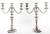 A Pair of Silver-plate Three-Light Candelabra, , each having a baluster form standard with scrolling candle arms and raised on a
